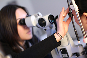 Comprehensive eye exam Dr. Carmen Tran doing an eye exam